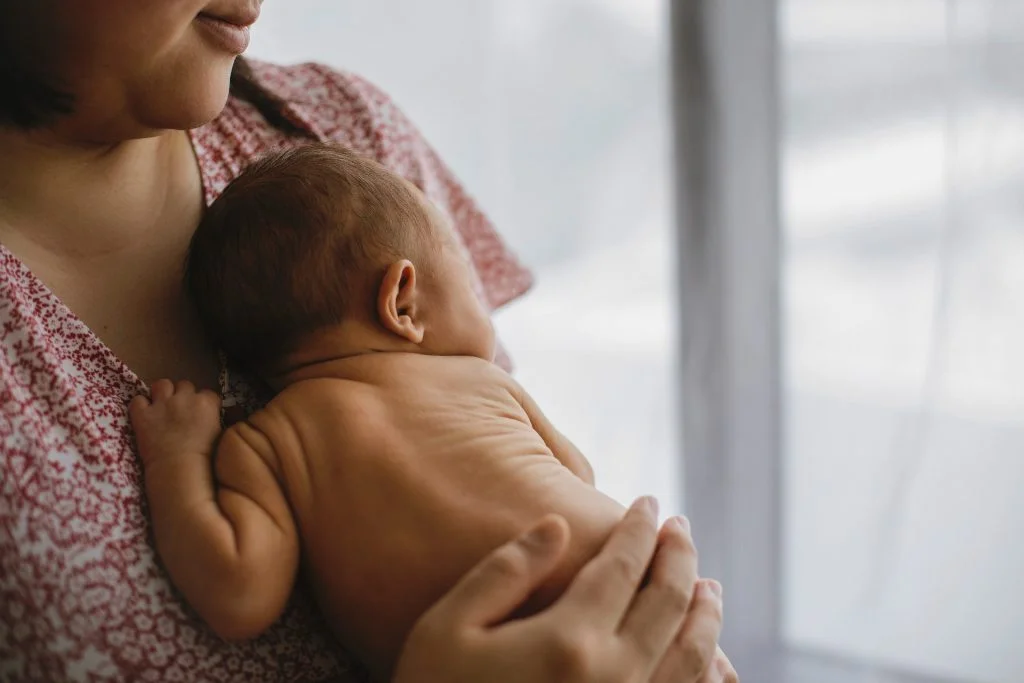 Mother holding newborn child