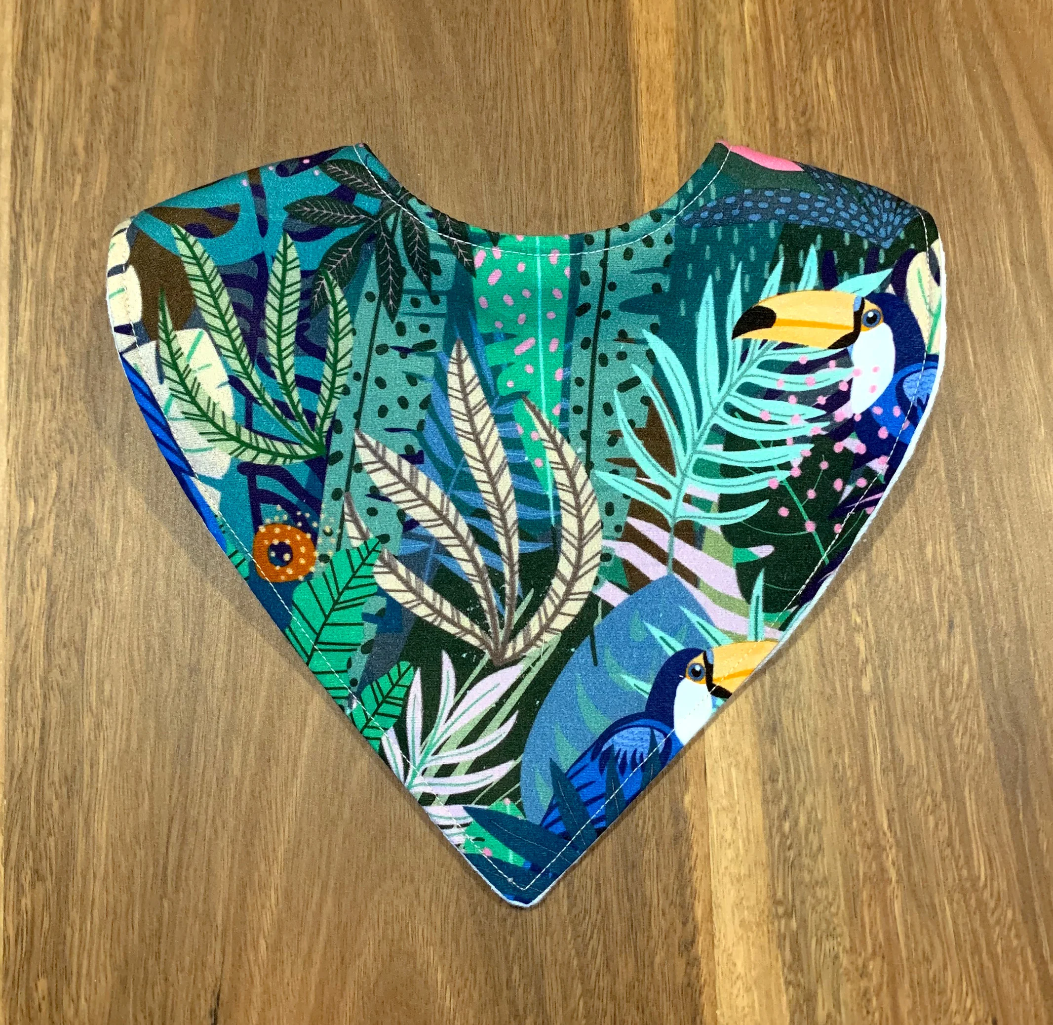 Toucans in jungle pattern on dribble bib