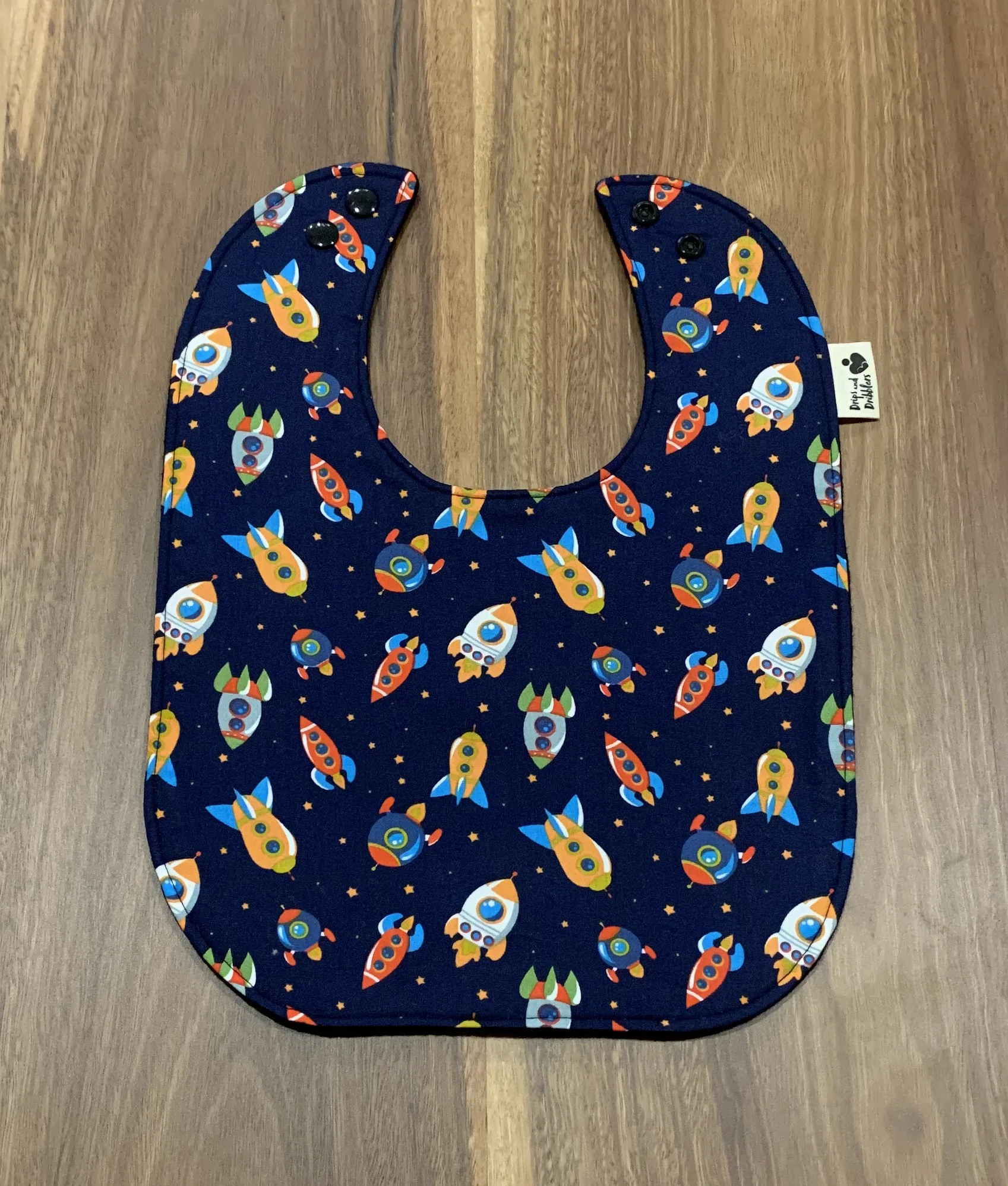 Meal sized bib with space rockets on it