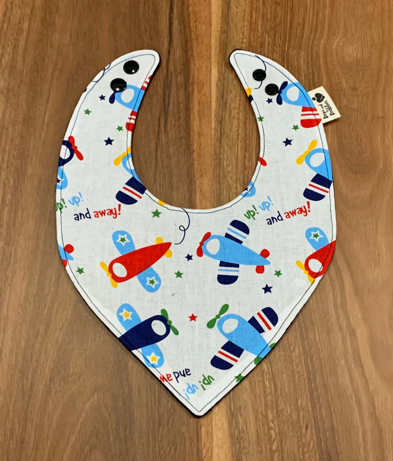 Planes and up up and away text pattern on dribble bib