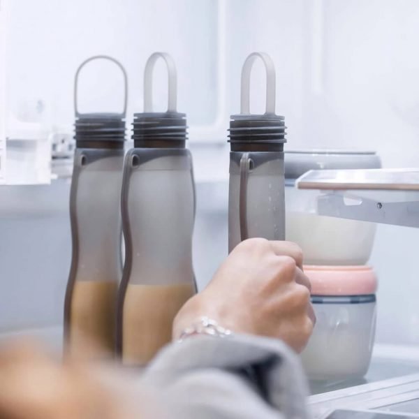 Three Haakaa silicone milk storage bag in fridge upright