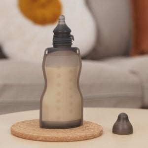 Haakaa Squeeze & Feed Attachment Set on storage bottle