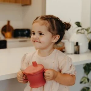 Child drinking from haakaa silicone sip-n-snack cup