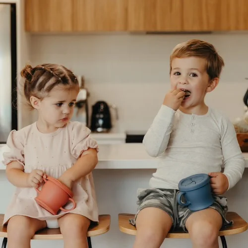 Children using haakaa silicone sip-n-snack cups